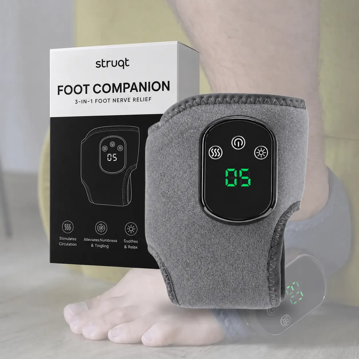 The Foot Companion massage device worn on a foot, beside its retail box